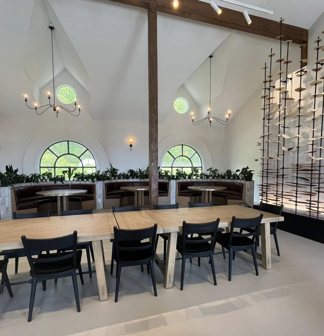Completed Domaine Le Clos Jordanne tasting room with dining table, booth seating, and finished art installation