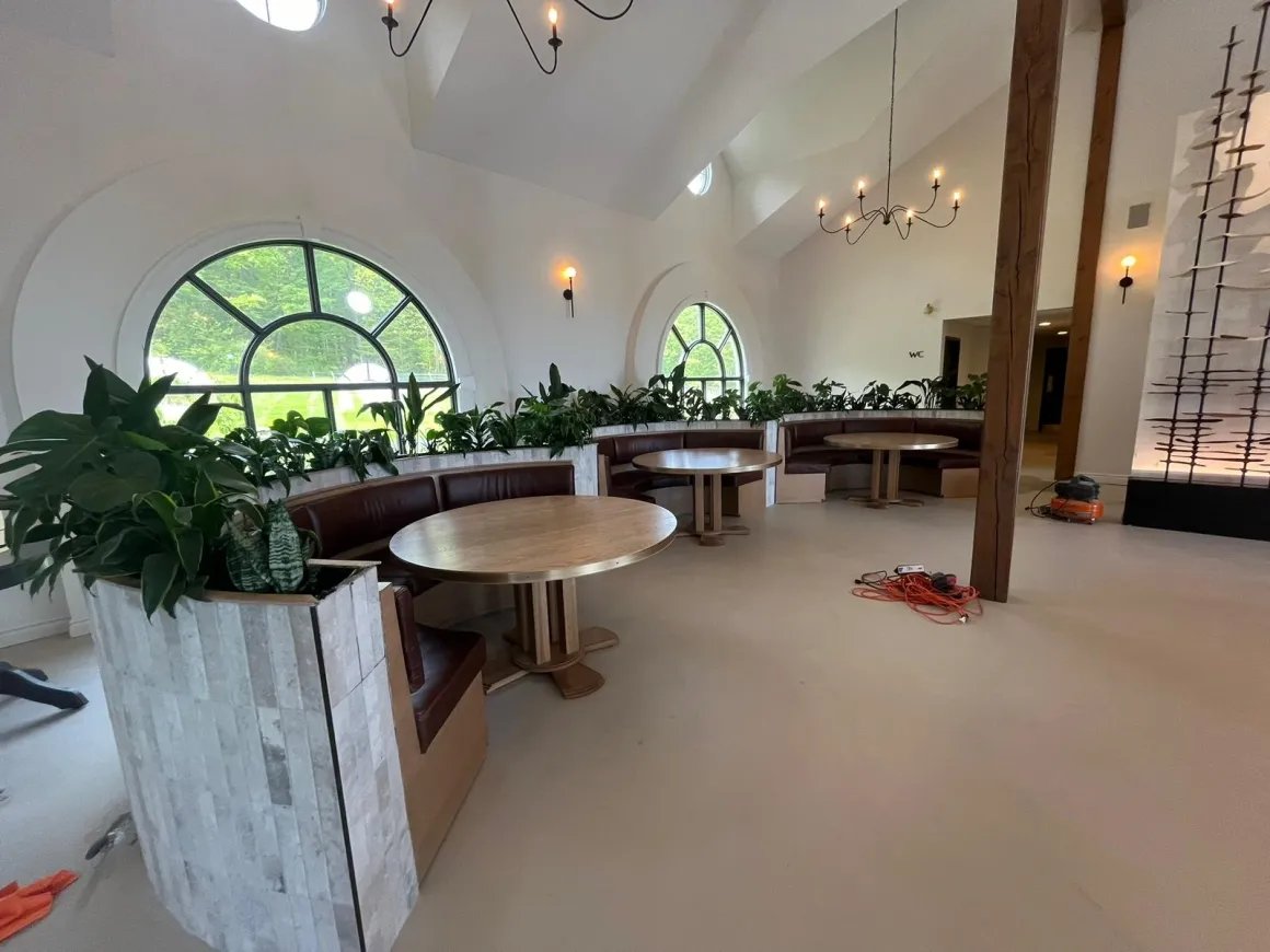 Domaine Le Clos Jordanne tasting room nearing completion, with booth seating, arched windows, and millwork installed